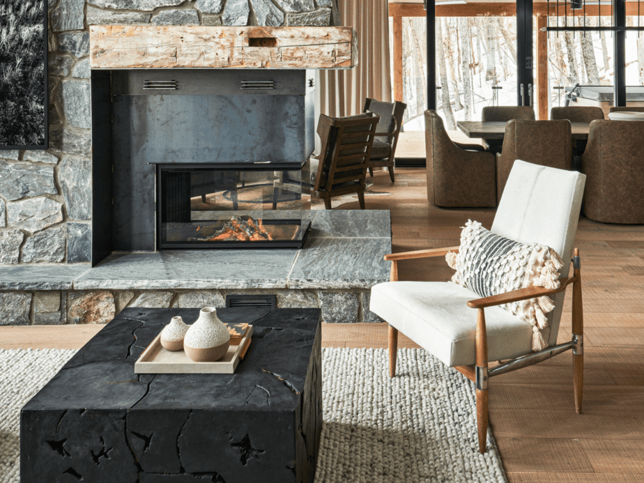 What is boho farmhouse style? Boho chair in front of stone fireplace.